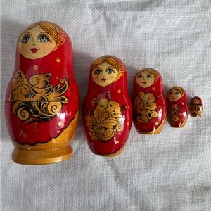 Hand-painted wooden matryoshka nesting dolls in Khokhloma style